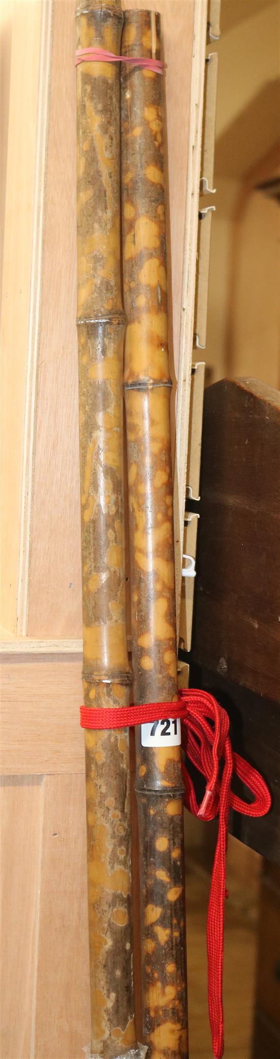 Bamboo curtain poles and fixings, and a quantity of curtain rings, W.185cm